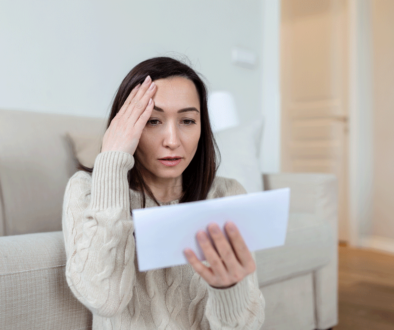 portrait-of-a-worried-asian-woman-looking-at-received-letter-at-home-beautiful-woman-with-worried-facial-expression-looking-at-received-mail-web