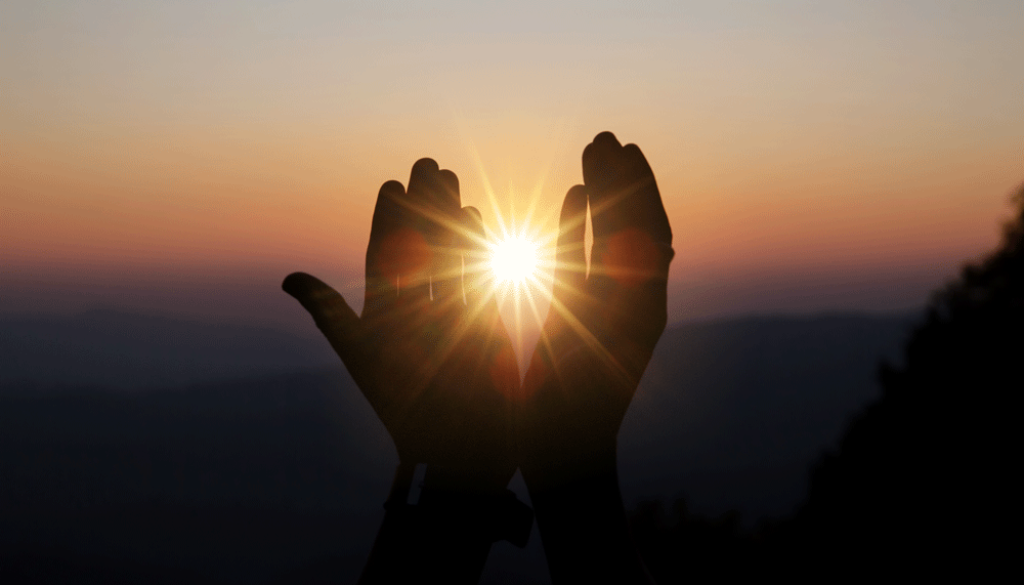 spiritual-prayer-hands-sun-shine-with-blurred-beautiful-sunset
