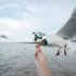 Man hand feeding Seagull bird. Seagull flying to eat food from